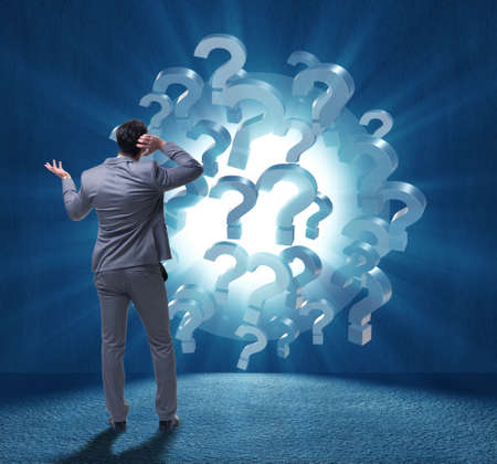The businessman in uncertainty concept with question marksの写真素材