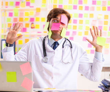 The male doctor with many conflicting priorititesの写真素材