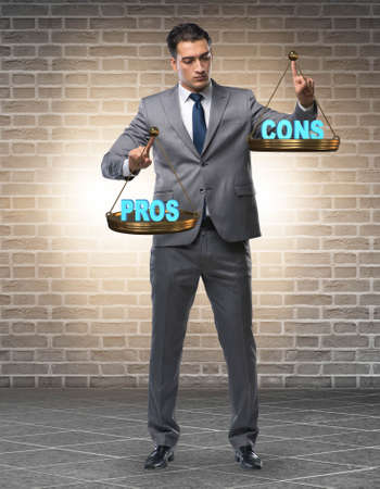 Businessman choosing pros and consの写真素材