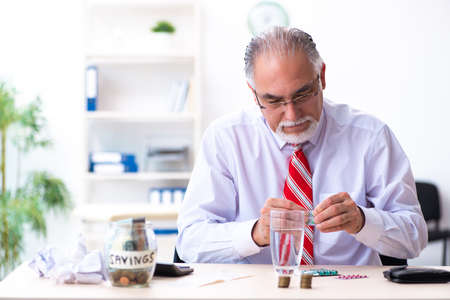 Old male accountant in budget planning concept