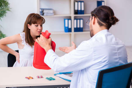 Young woman visiting male doctor gastroenterologistの写真素材
