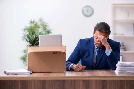 Young man being fired from his workplaceの写真素材