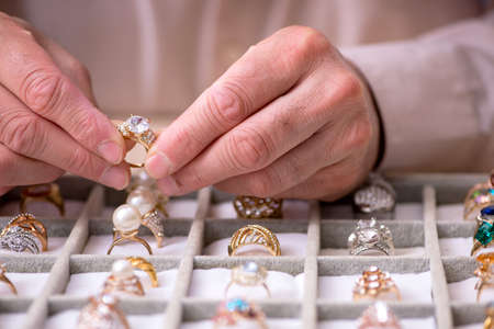 Old male jeweler at workshop