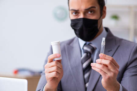 Young male employee in self-quarantine concept