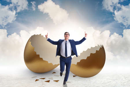 Businessman breaking out of golden egg