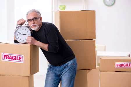 Old male professional mover doing home relocation