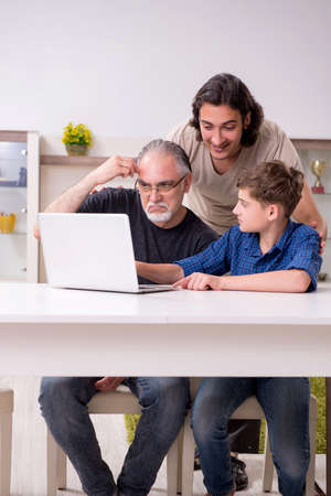 Grandfather learning new technology from son and grandson