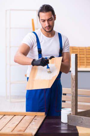 Young male contractor working in workshopの写真素材