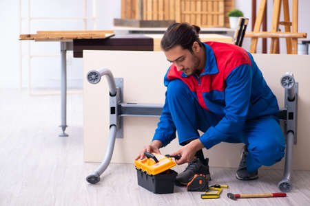 Young male contractor working in workshopの写真素材