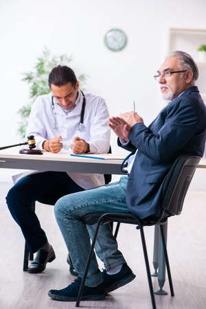 Male doctor in courthouse meeting with lawyerの写真素材