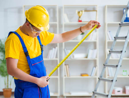 The young contractor doing repair works at office