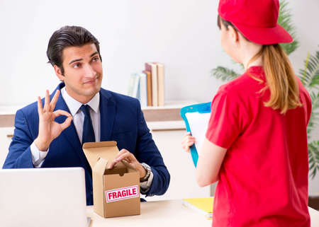 Courier delivering parcel to the office
