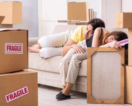 Young couple moving to new flat with fragile thingsの写真素材