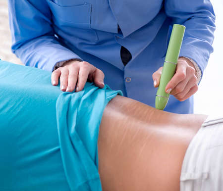 The patient in clinic undergoing laser scar removal
