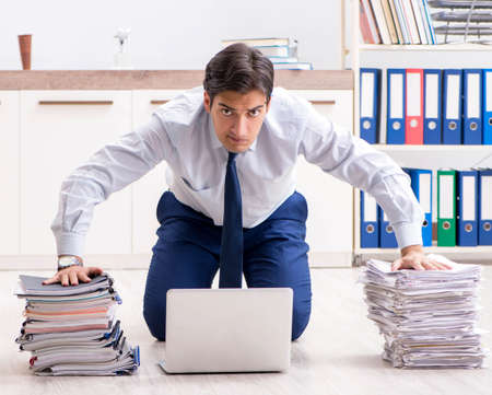 Extremely busy employee working in the officeの写真素材