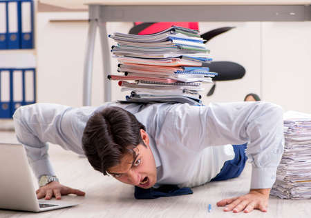 Extremely busy employee working in the office
