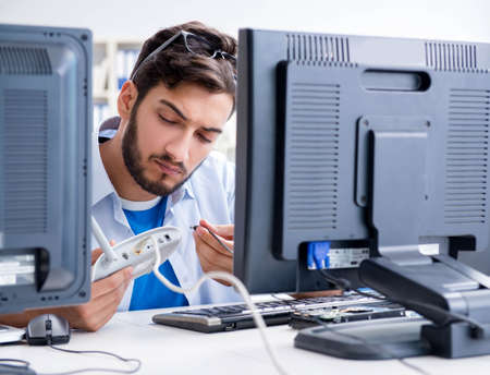 IT technician looking at IT equipment