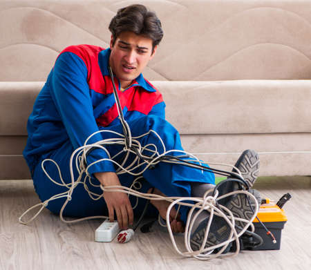 Electrician contractor with tangled cablesの写真素材