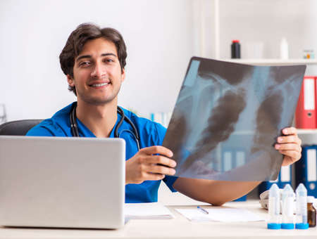 Male doctor radiologist with x-ray can imageの写真素材