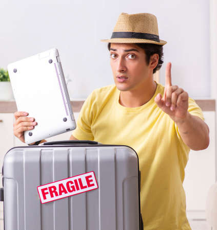 Man going on vacation with fragile suitcasesの写真素材