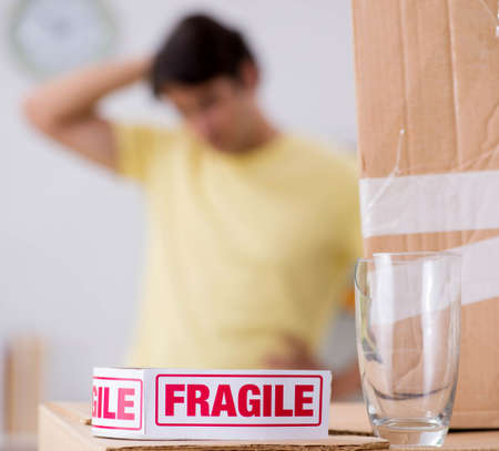 The man moving house and relocating with fragile itemsの写真素材
