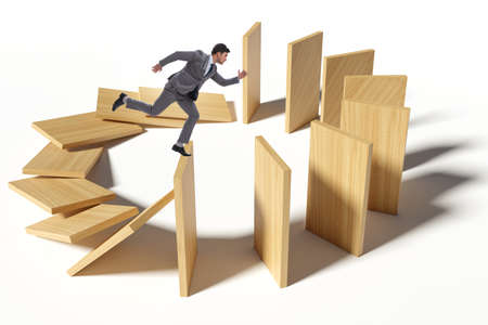 Businessman in domino effect conceptの写真素材