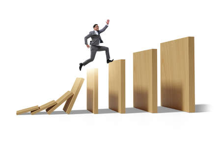 Businessman in the domino effect conceptの写真素材