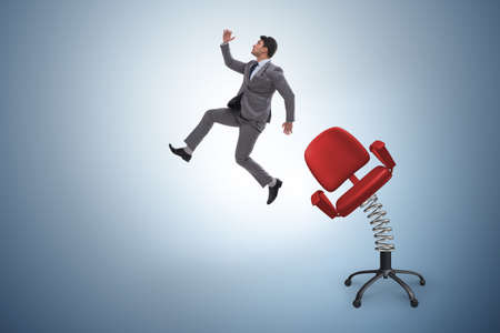 Promotion concept with businessman ejected from chairの写真素材