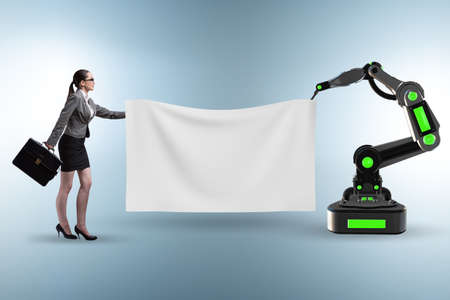 Business people and blank poster supported by robotic armsの写真素材