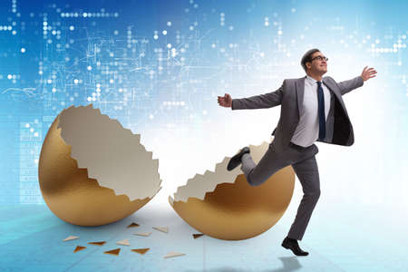 Businessman breaking out of golden egg