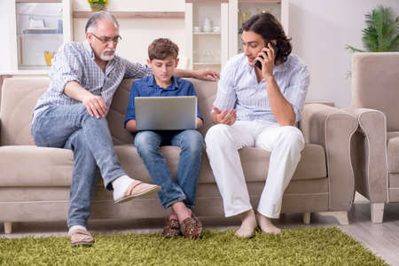 Boy and his father and his grandfother indoor