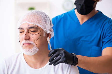 Old man visiting male doctor for plastic surgeryの写真素材
