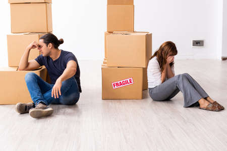 Young pair and many boxes in divorce settlement concept
