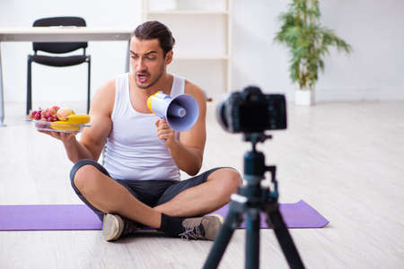 Young male blogger in dieting conceptの写真素材