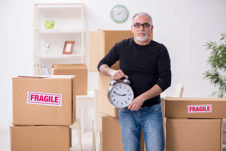 Old male professional mover doing home relocationの写真素材