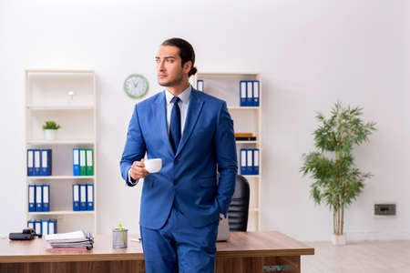 Young male businessman employee working in the officeの写真素材