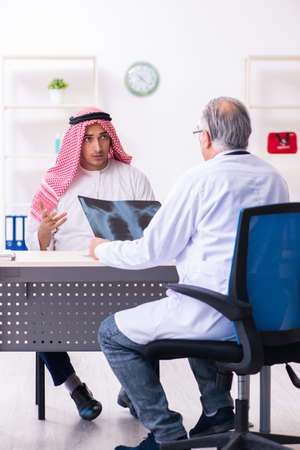 Young male arab visiting experienced male doctorの写真素材