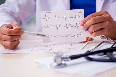 Young male doctor cardiologist working in the clinicの写真素材