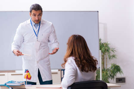 Young male doctor cardiologist and female student in the classroの写真素材