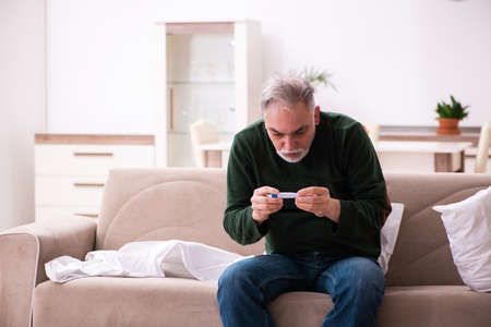 Old man suffering at homeの写真素材