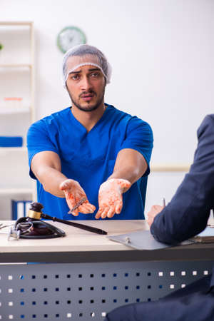 Male doctor in courthouse meeting with advocateの写真素材