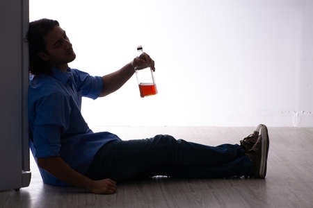 Young man suffering from alcoholismの写真素材