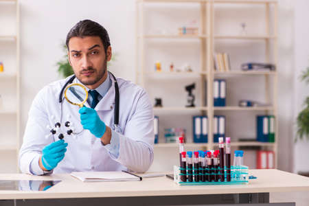 Doctor working in lab in coronavirus COVID-19 conceptの写真素材