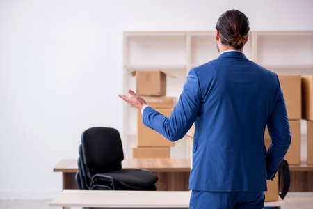 Young male employee in relocation conceptの写真素材