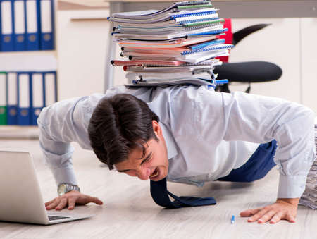 Extremely busy employee working in the officeの写真素材