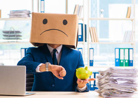 Unhappy man with box instead of his headの写真素材