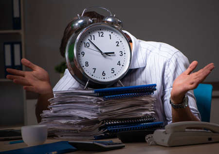 Young financial manager working late at night in officeの写真素材