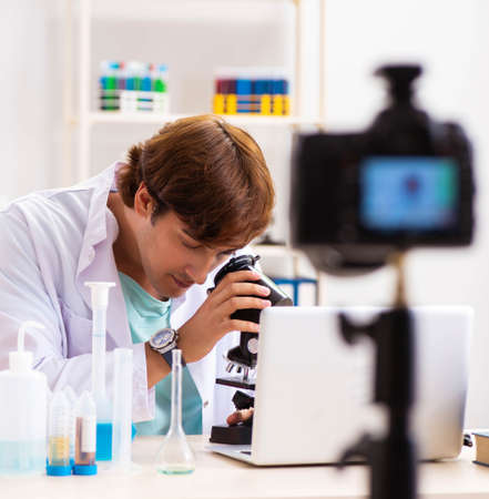 Chemist blogger recording video for his blogの写真素材