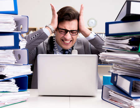 Busy businessman under stress due to excessive work