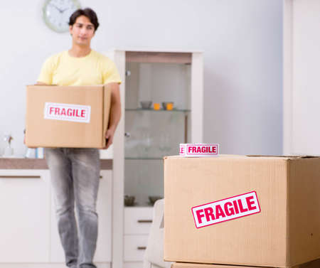 Man moving house and relocating with fragile items